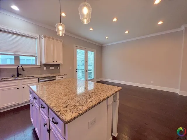 a kitchen with center island table and chairs