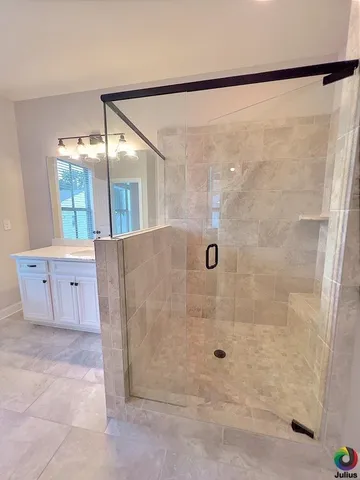 a bathroom with a glass shower door