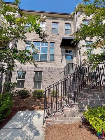 a view of a house with a small yard and plants