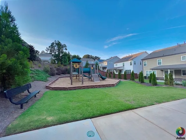 a kitchen with a table chairs stove and cabinets