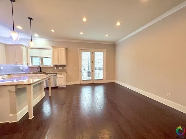 a view of a kitchen with a sink and wooden floor
