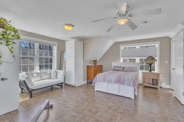 a living room with a bed furniture and a window