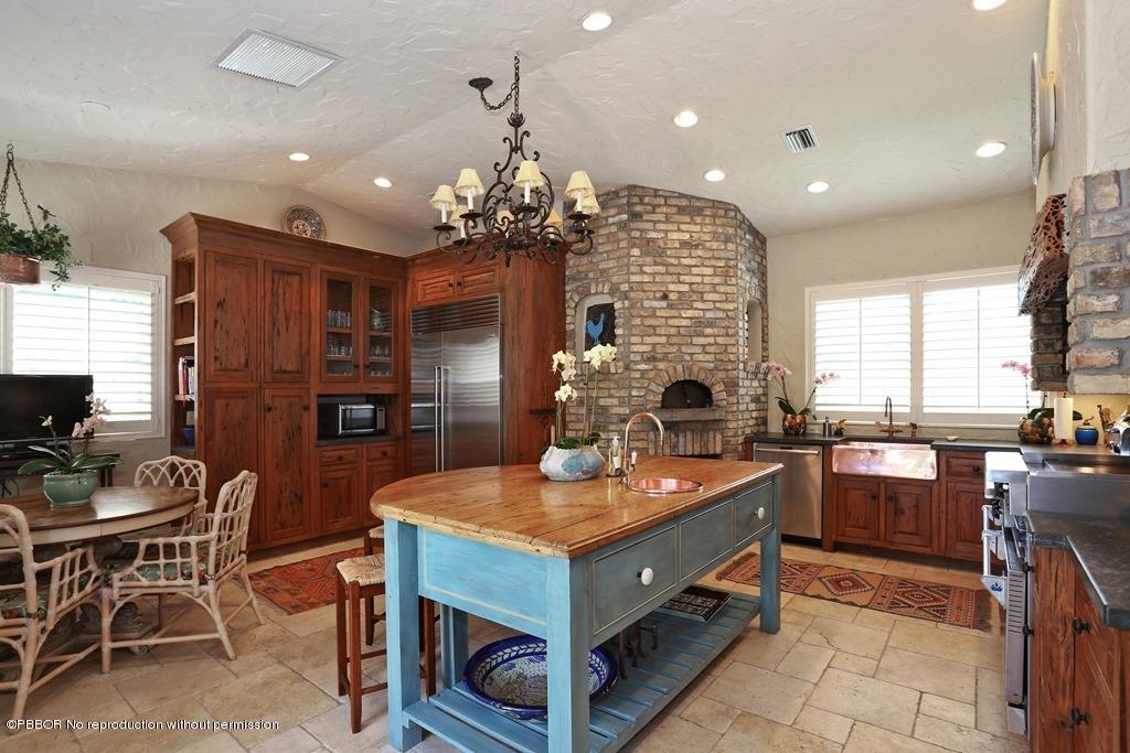 292 Orange Grove Road Palm Beach, FL 33480 - Photo 8 of 16 a kitchen with sink refrigerator and dining table