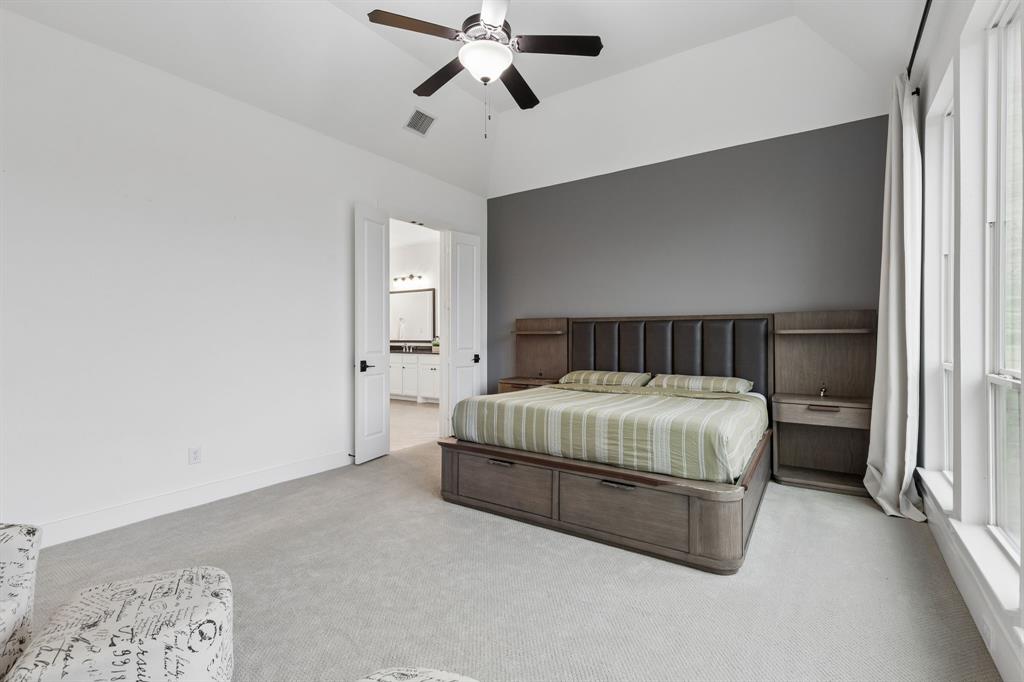 566 Broadleaf Way Haslet, TX 76052 - Photo 16 of 38 Spacious room featuring vaulted ceilings, a ceiling fan with integrated lighting, and light gray carpeting