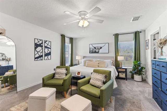 a bedroom with furniture and a large window