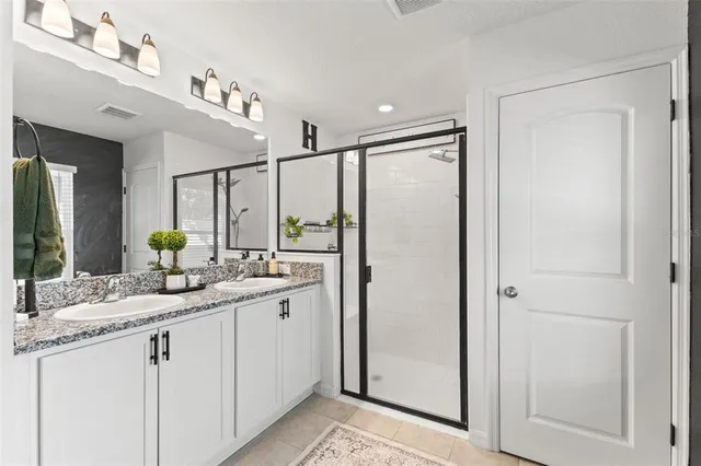 a bathroom with a double vanity sink and mirror