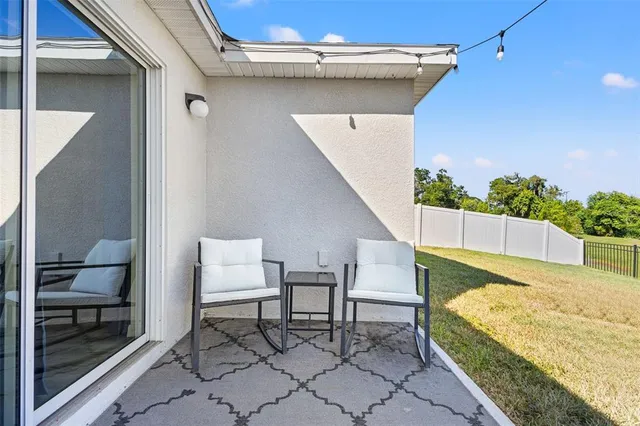 a balcony with table and chairs