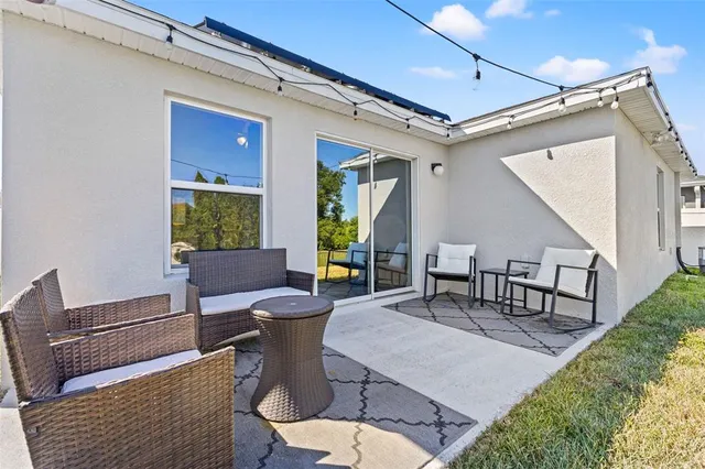 a outdoor space with chairs a couch and a window