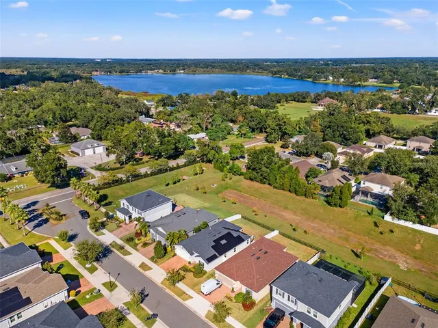 an aerial view of residential houses with outdoor space and river
