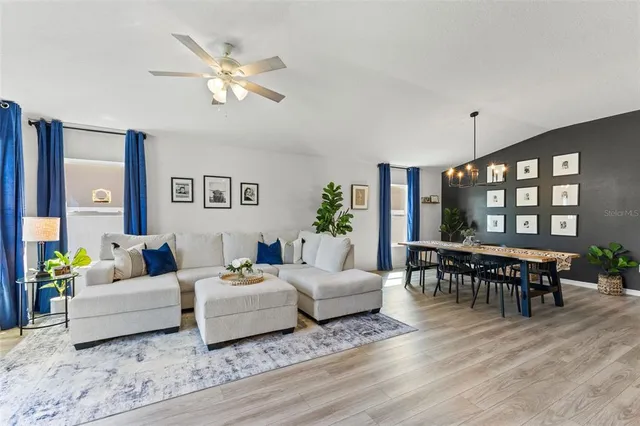 a living room with furniture and wooden floor