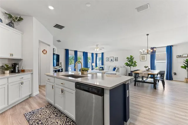 a kitchen with a sink stove and cabinets