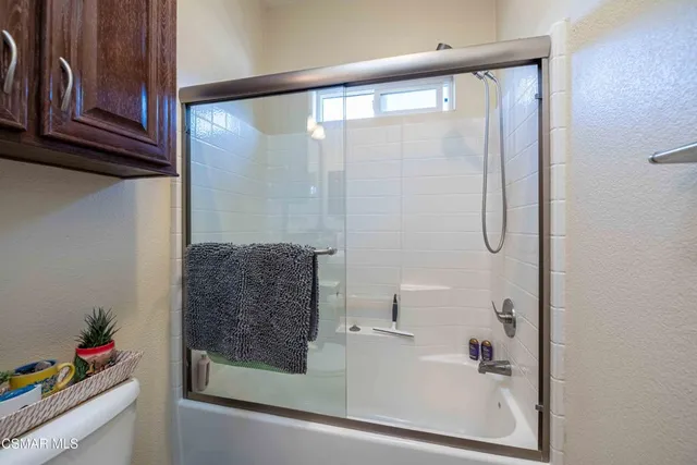 a bathroom with a shower and a sink