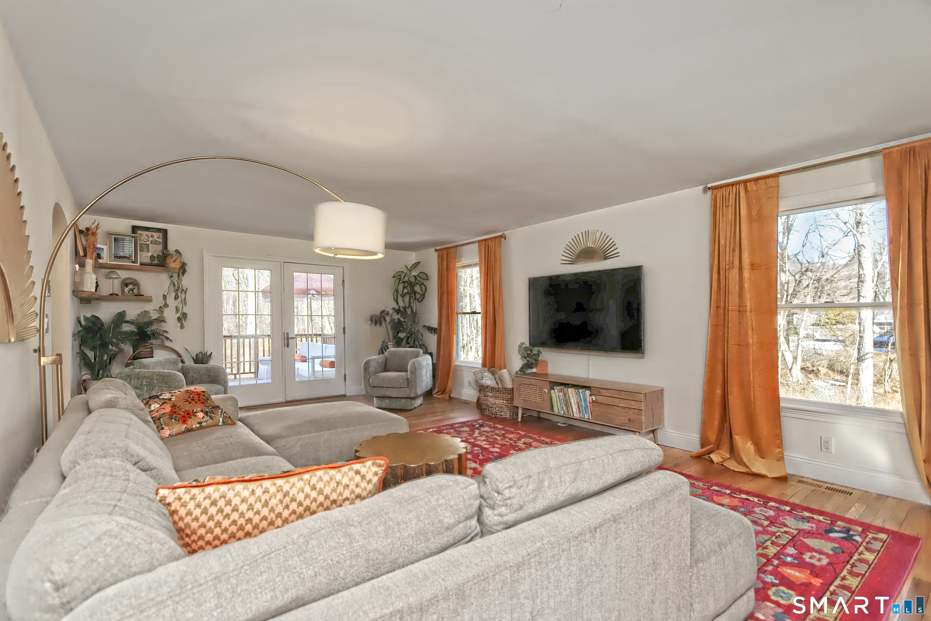 215 Wheeler Road Monroe, CT 06468 - Photo 11 of 22 a living room with a couch and a flat screen tv