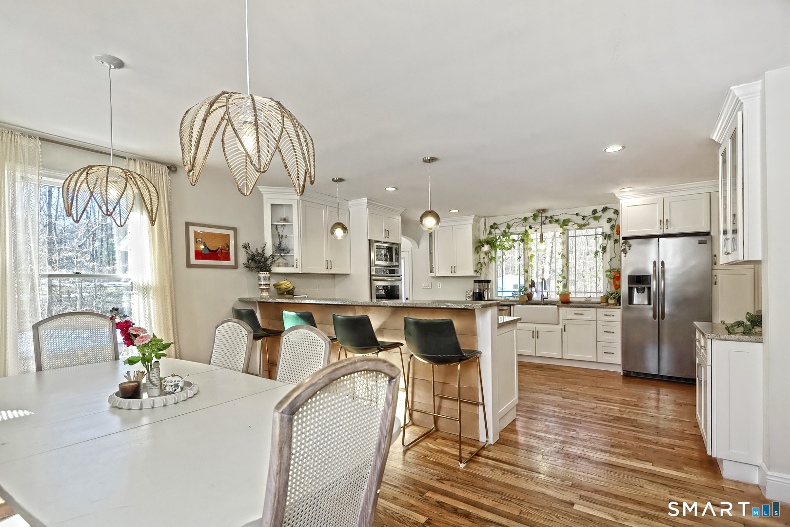215 Wheeler Road Monroe, CT 06468 - Photo 22 of 22 a kitchen with stainless steel appliances granite countertop a refrigerator a sink dishwasher a dining table and chairs with wooden floor