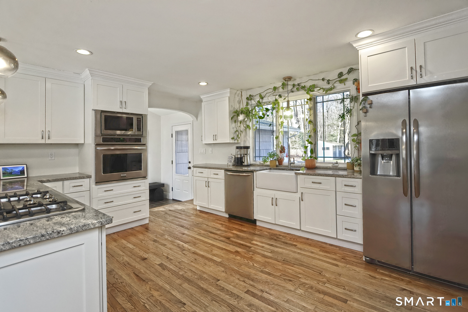 215 Wheeler Road Monroe, CT 06468 - Photo 4 of 22 a kitchen with white cabinets and stainless steel appliances