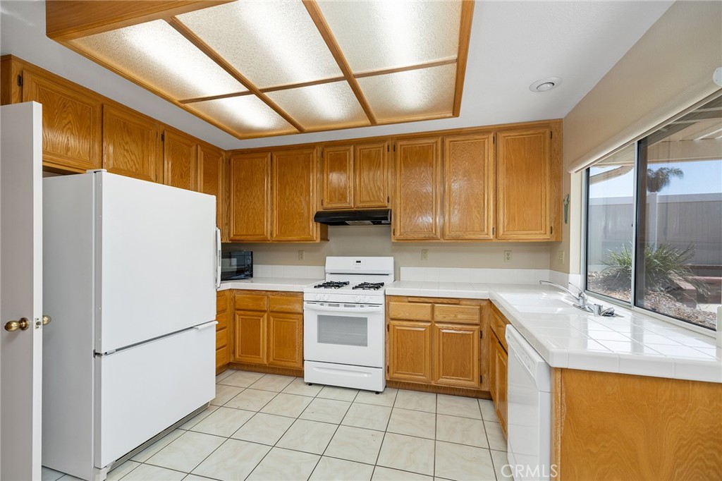 31375 Willowood Way Menifee, CA 92584 - Photo 14 of 43 a kitchen with a white cabinets and white appliances
