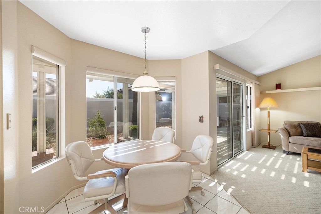 31375 Willowood Way Menifee, CA 92584 - Photo 18 of 43 a dining room with furniture a chandelier and window