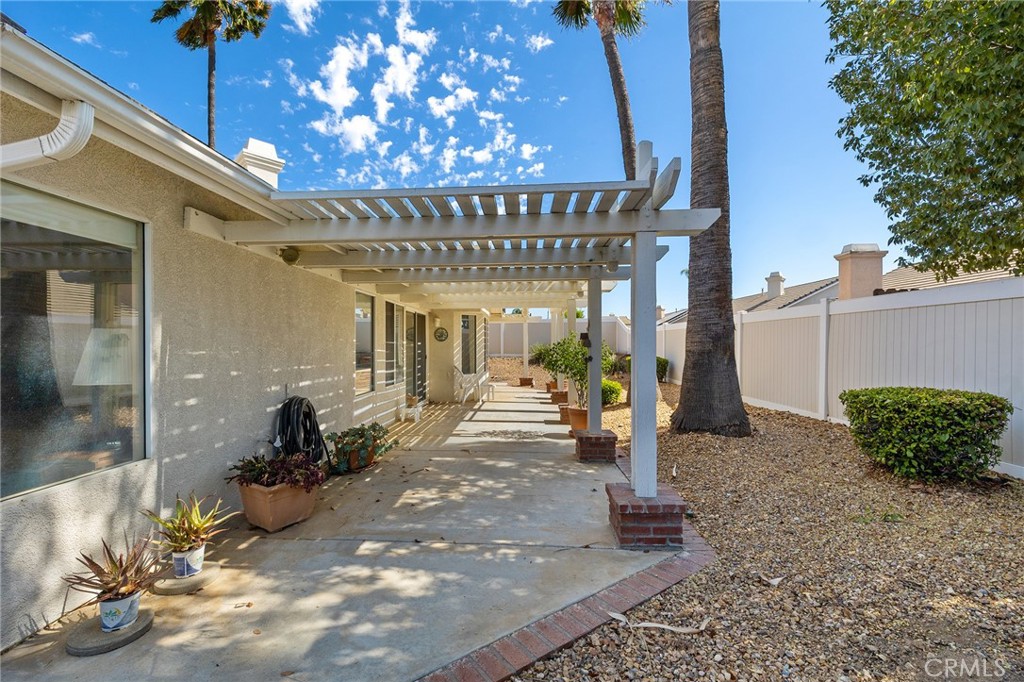 31375 Willowood Way Menifee, CA 92584 - Photo 30 of 43 a view of a porch with a table and chairs