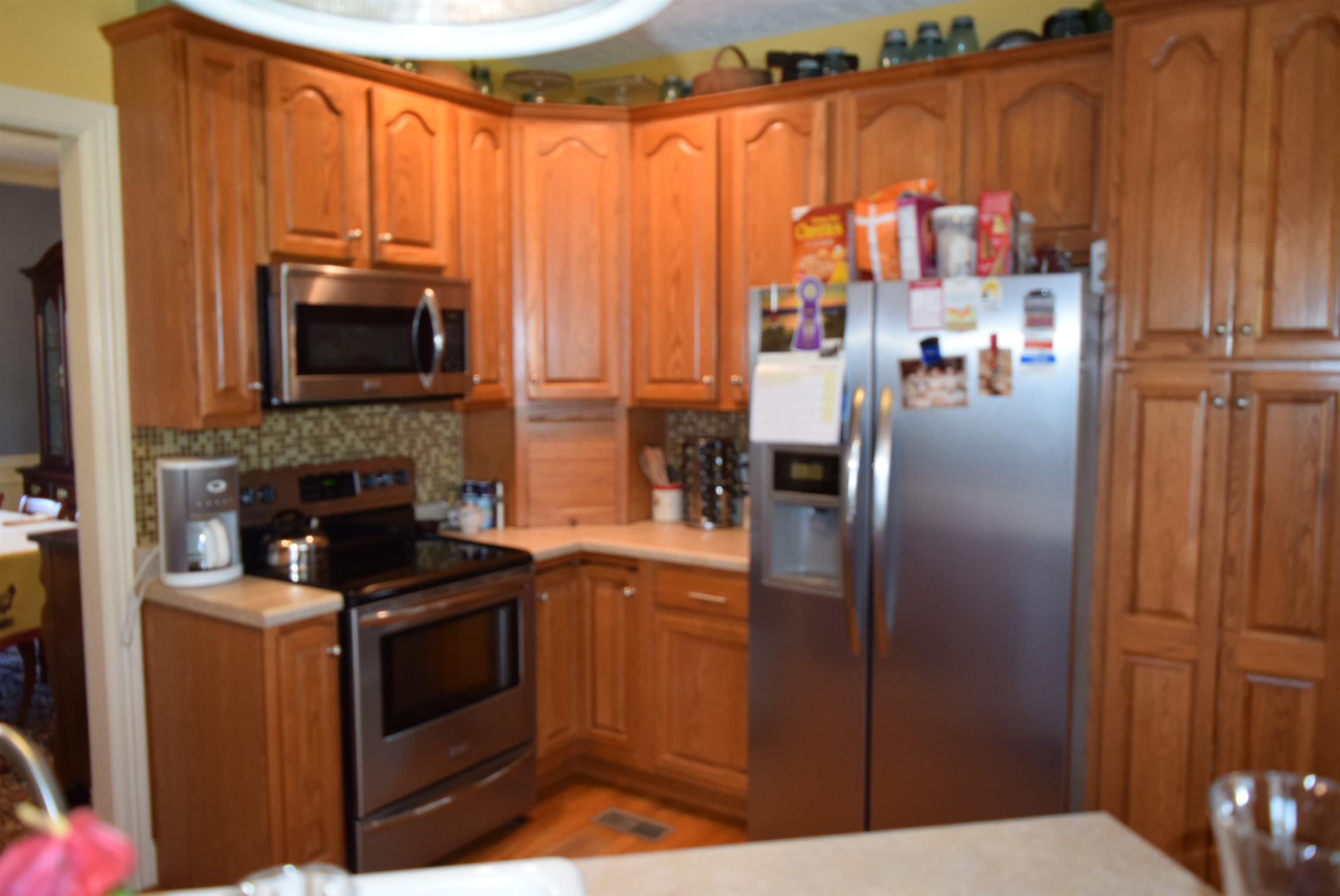 8936 Fredonia Road Manchester, TN 37355 - Photo 6 of 25 a kitchen with stainless steel appliances a refrigerator a stove a microwave and cabinets