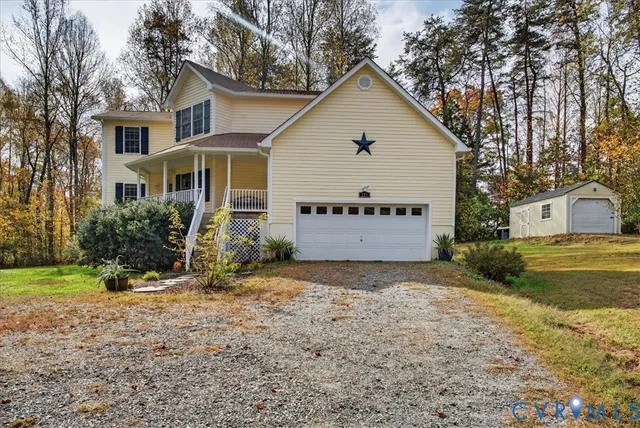a view of a house with a yard and garage