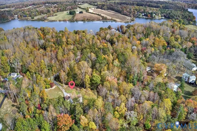 an aerial view of residential houses with outdoor space and trees