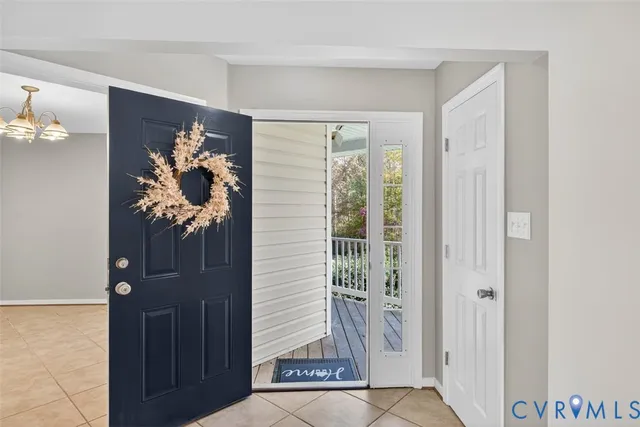 a view of a hallway with wooden floor and a potted plant