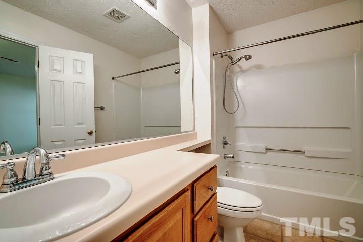 3913 Olde Coach Road Durham, NC 27707 - Photo 14 of 17 a bathroom with a granite countertop sink toilet and shower