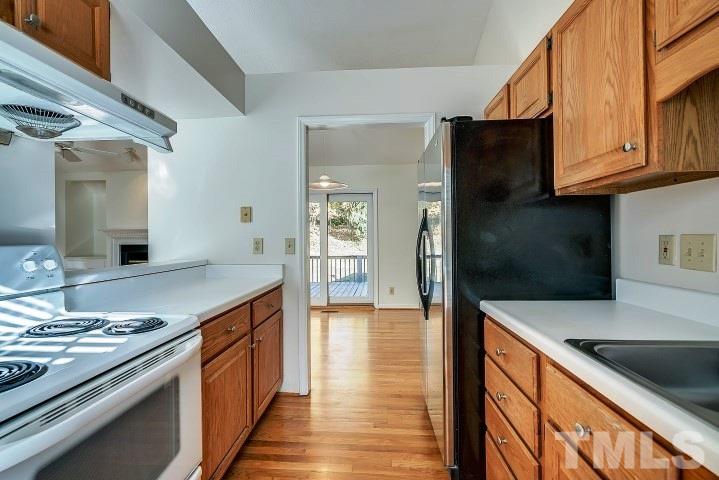 3913 Olde Coach Road Durham, NC 27707 - Photo 6 of 17 a kitchen with stainless steel appliances granite countertop a sink and a stove