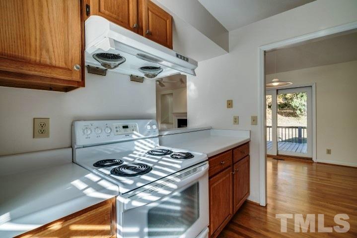3913 Olde Coach Road Durham, NC 27707 - Photo 7 of 17 a kitchen with stainless steel appliances granite countertop a stove and a wooden cabinets