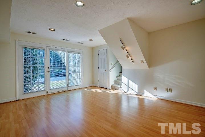 3913 Olde Coach Road Durham, NC 27707 - Photo 10 of 17 wooden floor in an empty room with a window
