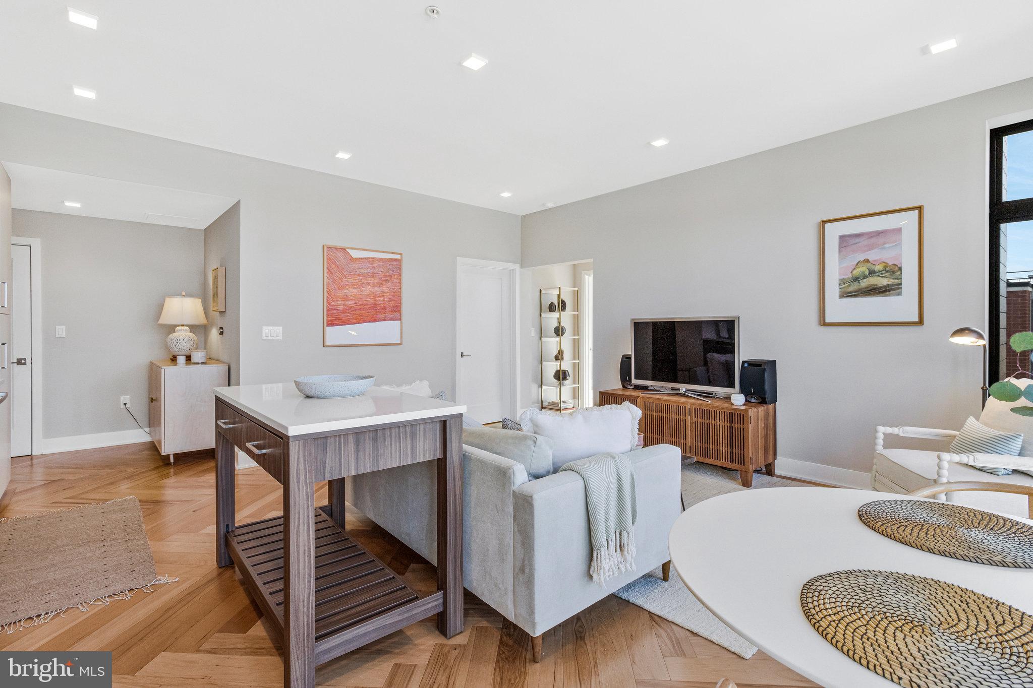 1345 K Street Southeast, Unit 406 Washington, DC 20003 - Photo 11 of 46 a living room with furniture and a flat screen tv
