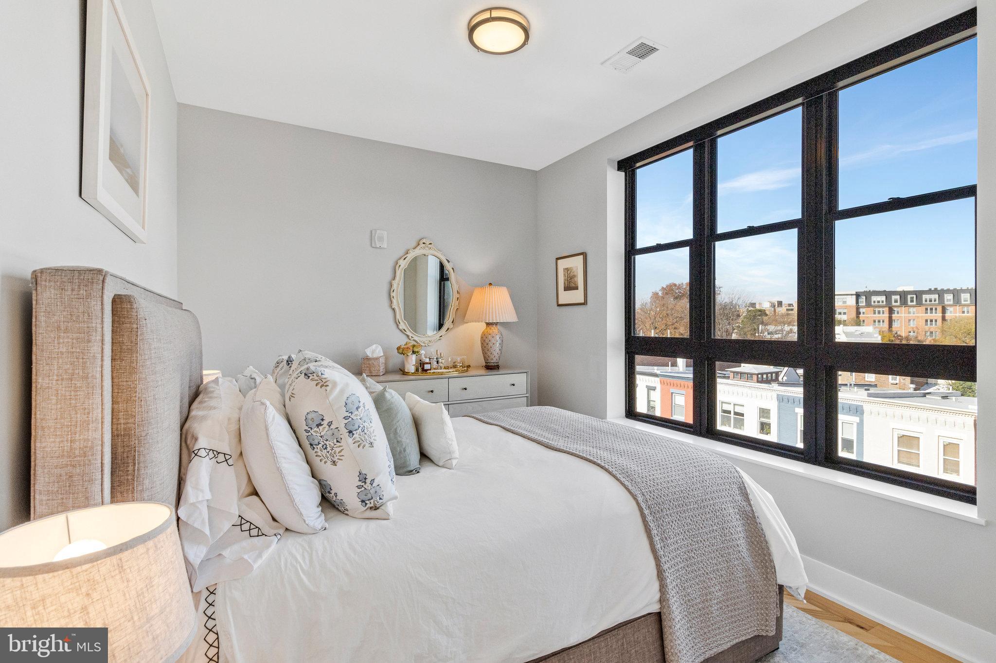 1345 K Street Southeast, Unit 406 Washington, DC 20003 - Photo 17 of 46 a bedroom with a large bed and a large window