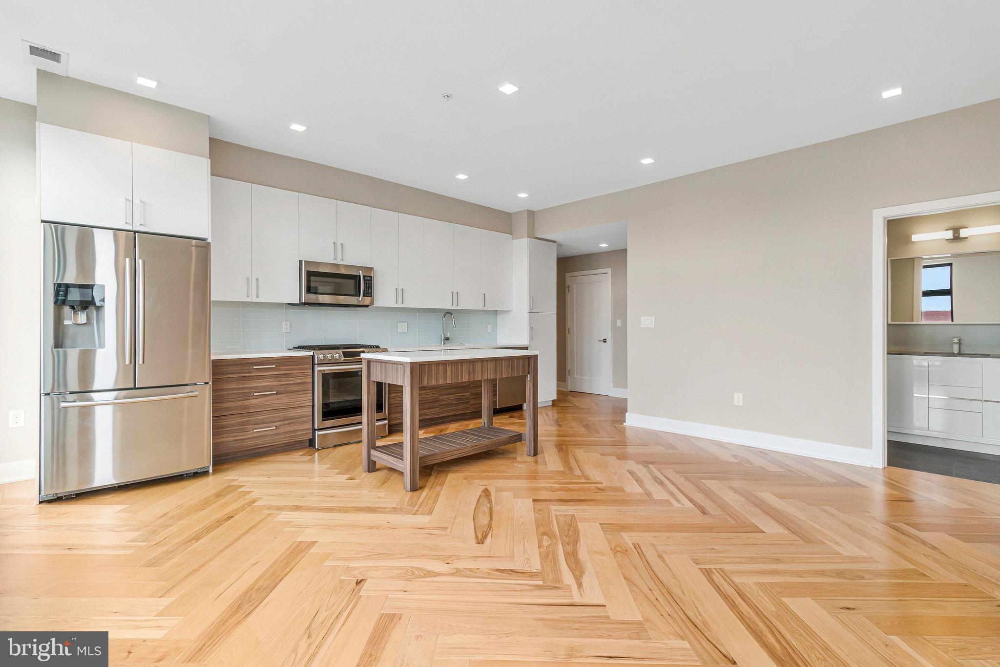 1345 K Street Southeast, Unit 406 Washington, DC 20003 - Photo 25 of 46 a kitchen with stainless steel appliances a stove a refrigerator and a sink