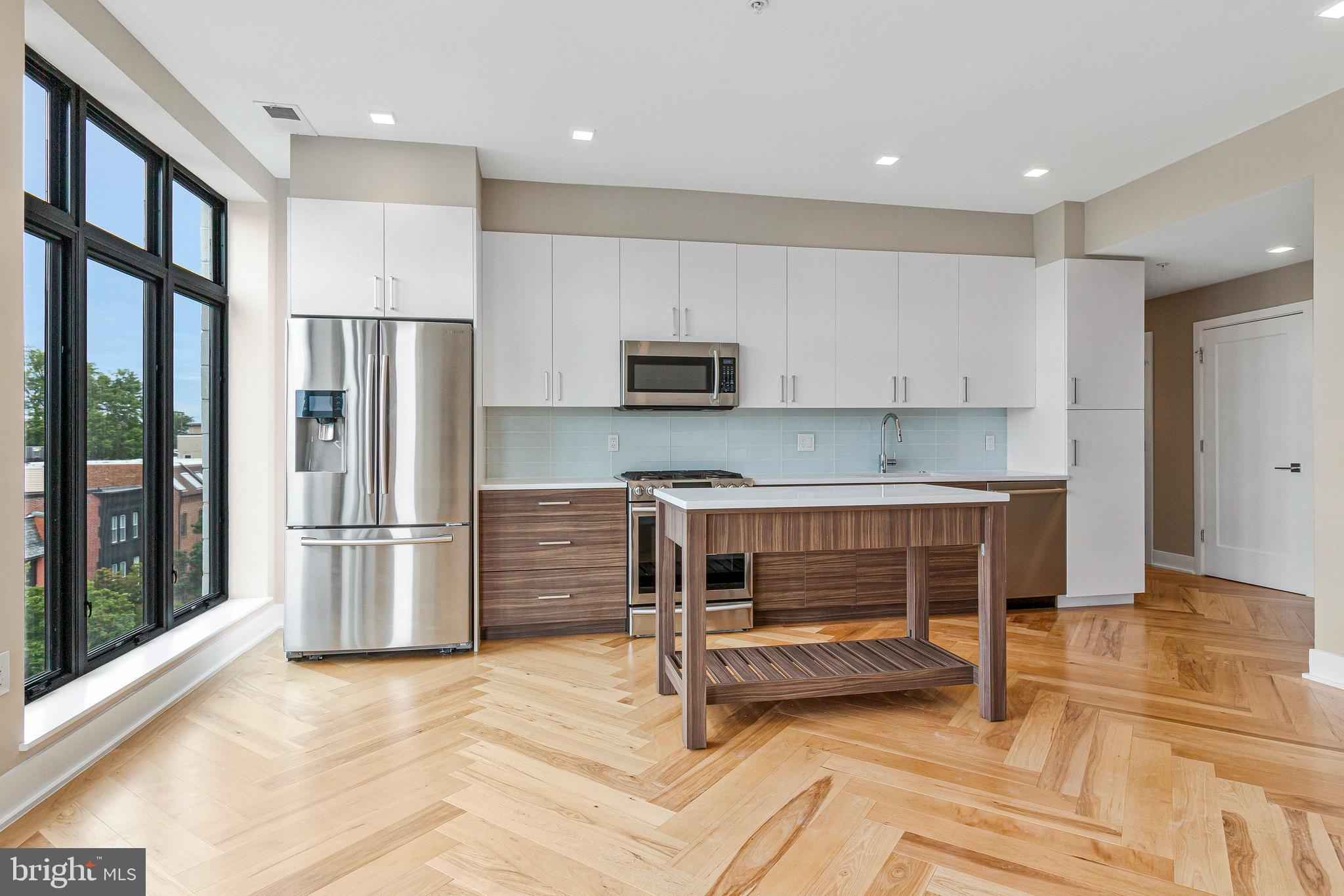 1345 K Street Southeast, Unit 406 Washington, DC 20003 - Photo 26 of 46 a kitchen with a refrigerator and a stove top oven