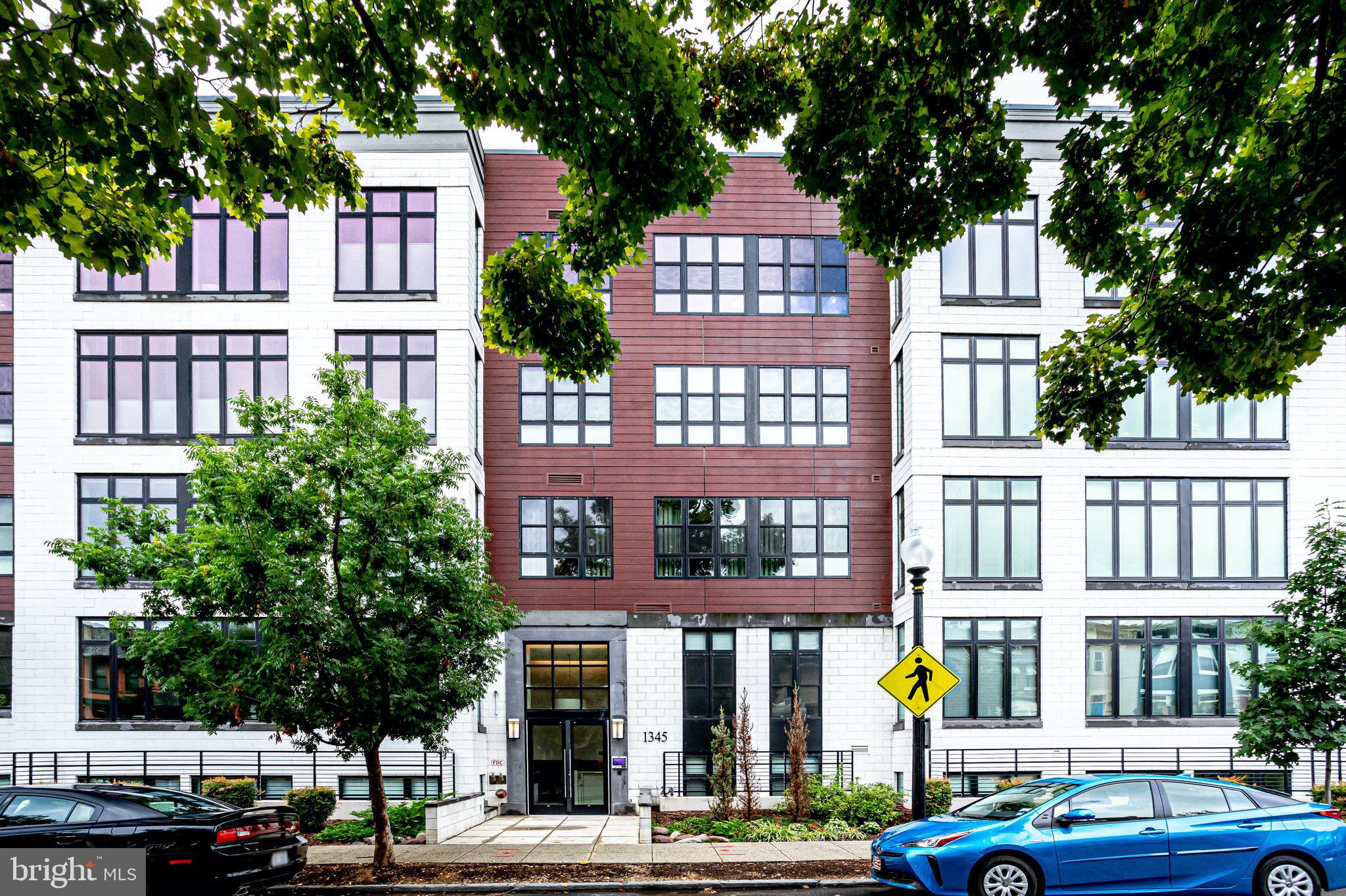 1345 K Street Southeast, Unit 406 Washington, DC 20003 - Photo 39 of 46 a front view of a building with street view and trees
