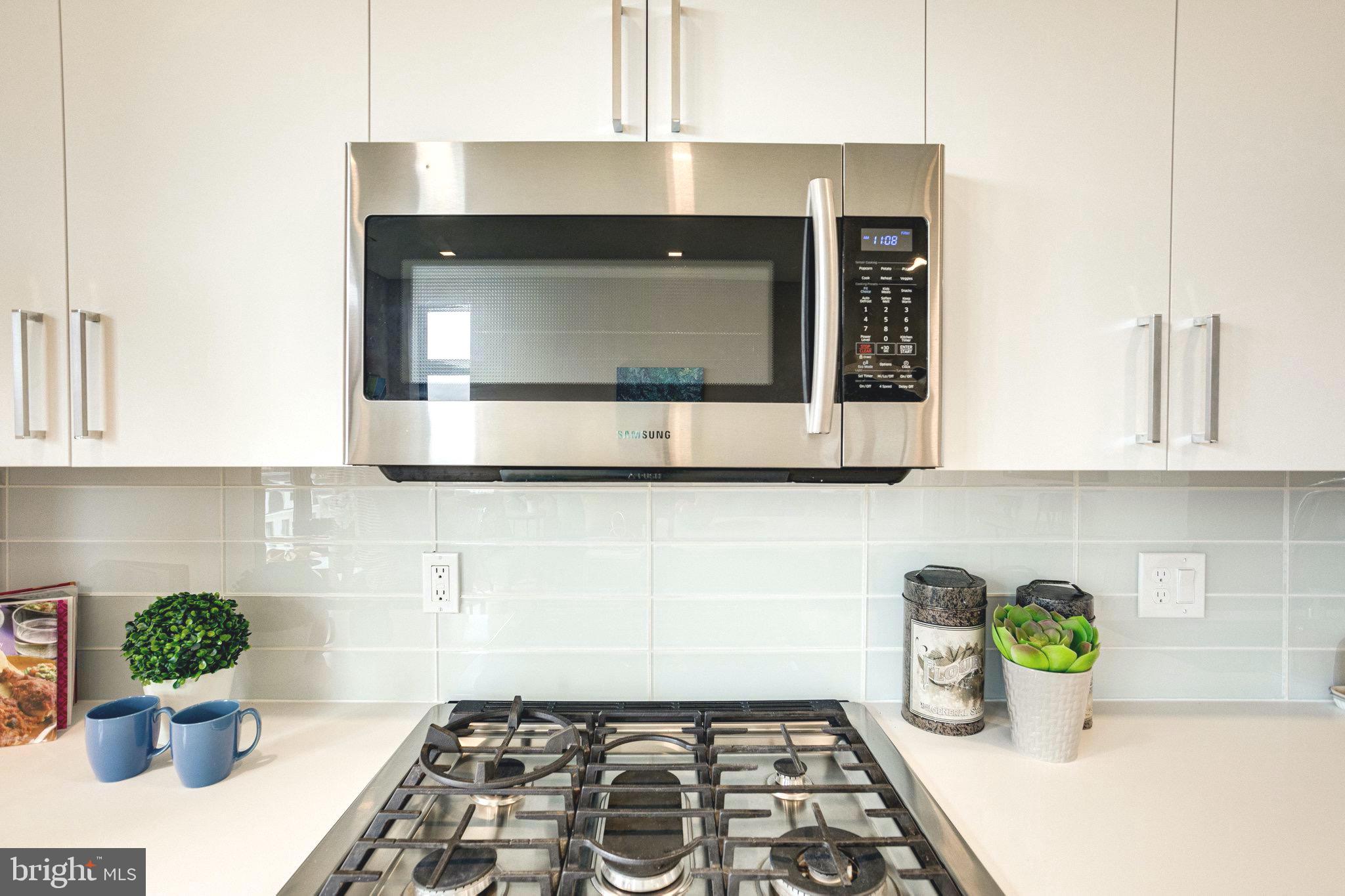 1345 K Street Southeast, Unit 406 Washington, DC 20003 - Photo 5 of 46 a kitchen with a stove and a microwave