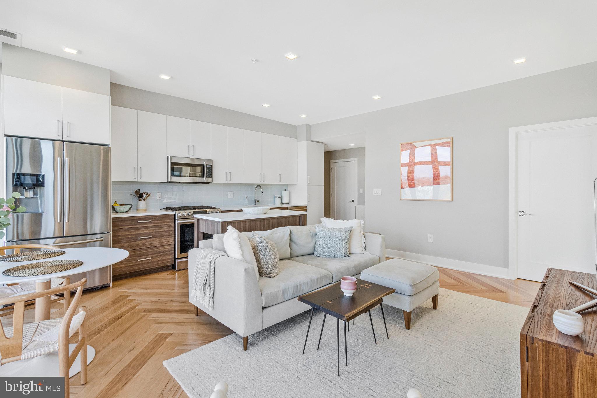 1345 K Street Southeast, Unit 406 Washington, DC 20003 - Photo 10 of 46 a living room with stainless steel appliances furniture and a kitchen view