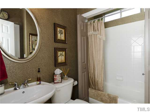 13136 Sargas Street Raleigh, NC 27614 - Photo 14 of 22 Signature John Wieland trait of Bath/Shower hidden behind doors when not in use. This bathroom is a must see! Bathroom