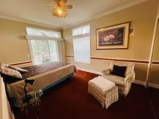 a bedroom with a bed and painting on the wall