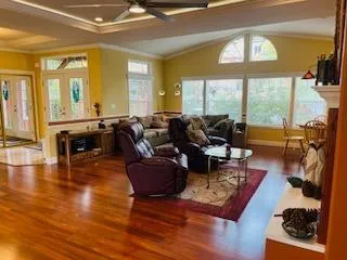 a living room with fireplace furniture and a large window