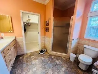 a bathroom with a granite countertop sink toilet and shower