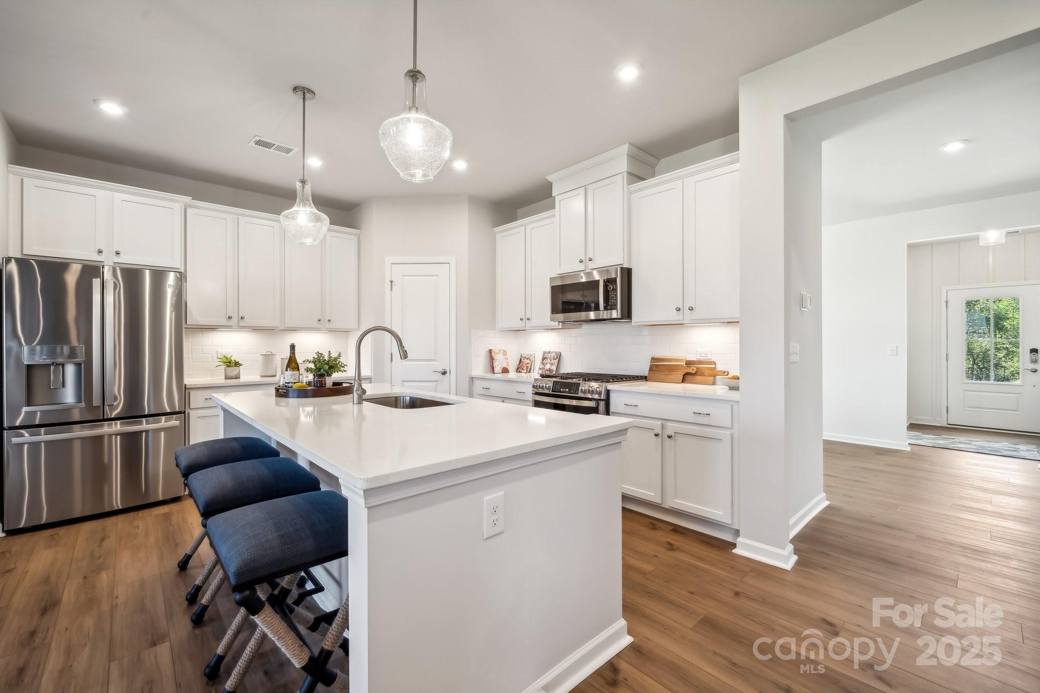 1095 Arundle Road Catawba, NC 28609 - Photo 8 of 34 a kitchen with white cabinets and stainless steel appliances
