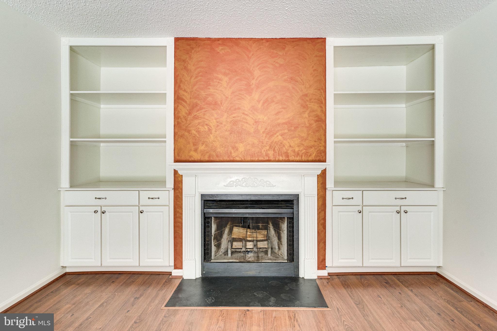 2403 Pondside Terrace Silver Spring, MD 20906 - Photo 21 of 45 Wood burning fireplace and built in shelves