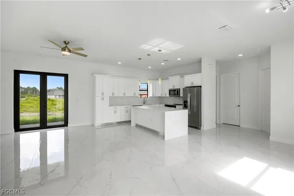 a view of kitchen with refrigerator and window
