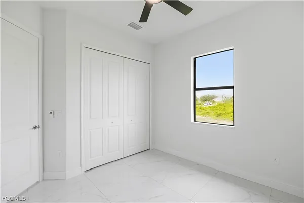 an empty room with windows and closet
