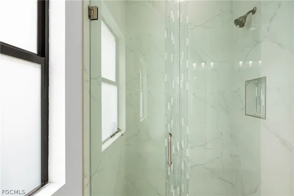 a bathroom with a glass shower door