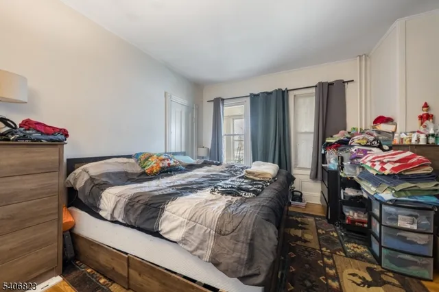 a bed sitting in a bedroom next to a window