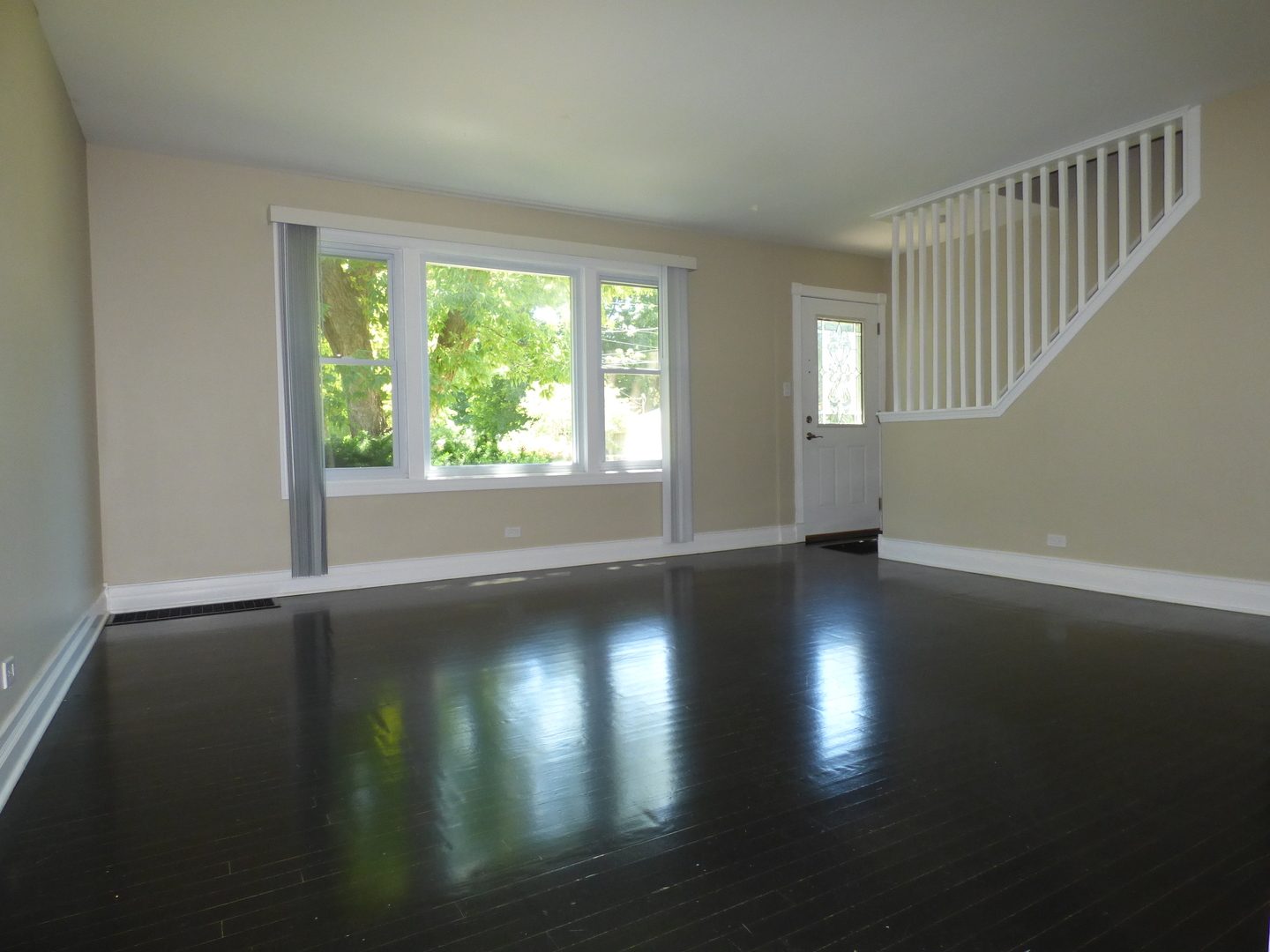 5416 Conrad Street Skokie, IL 60077 - Photo 2 of 14 a view of empty room with wooden floor and fan