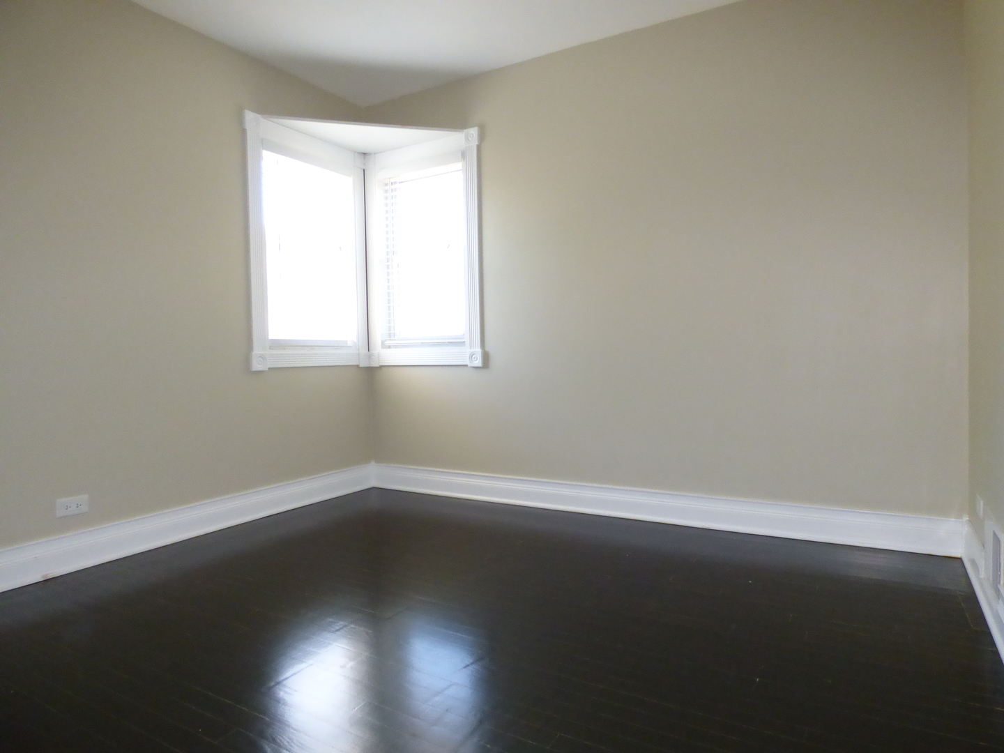 5416 Conrad Street Skokie, IL 60077 - Photo 5 of 14 an empty room with wooden floor and windows