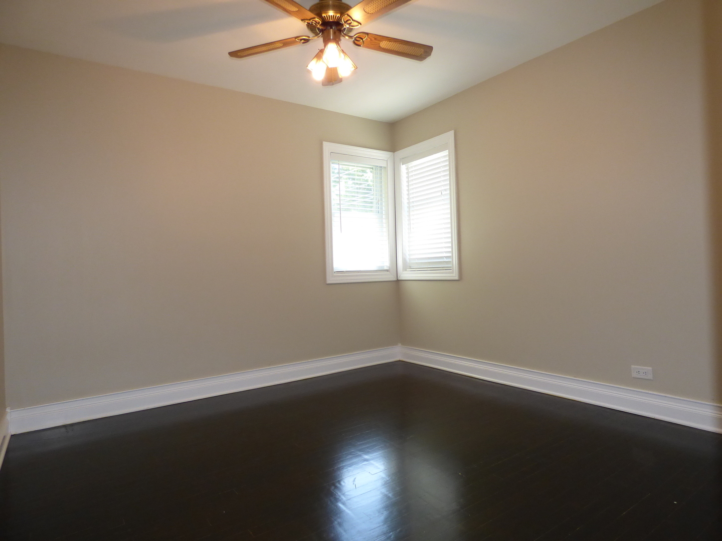 5416 Conrad Street Skokie, IL 60077 - Photo 6 of 14 a view of wooden floor and windows in a room